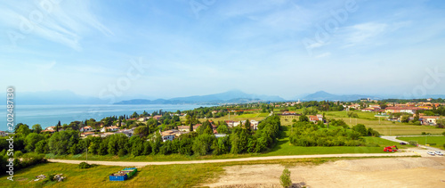 Garda Lake and high mountain in background. View from observation desk in GardaLand, Lombardy, Italy