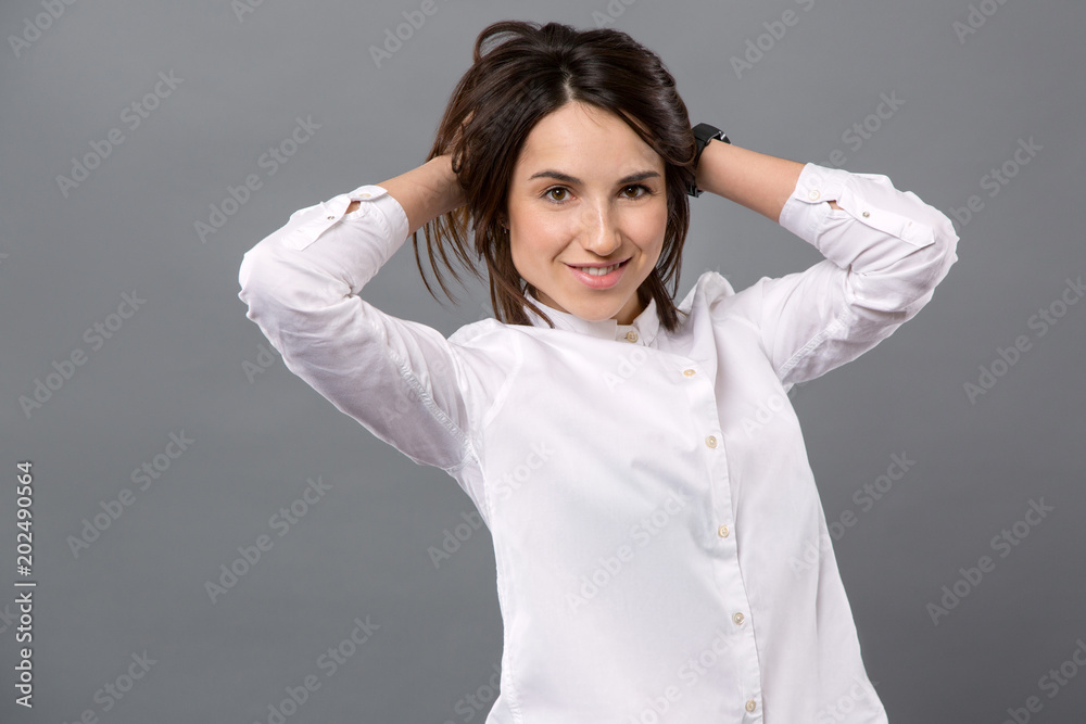 Magnetic look. Nice attractive woman touching her hair while looking at you Magnetic look. Nice attractive woman touching her hair while looking at you