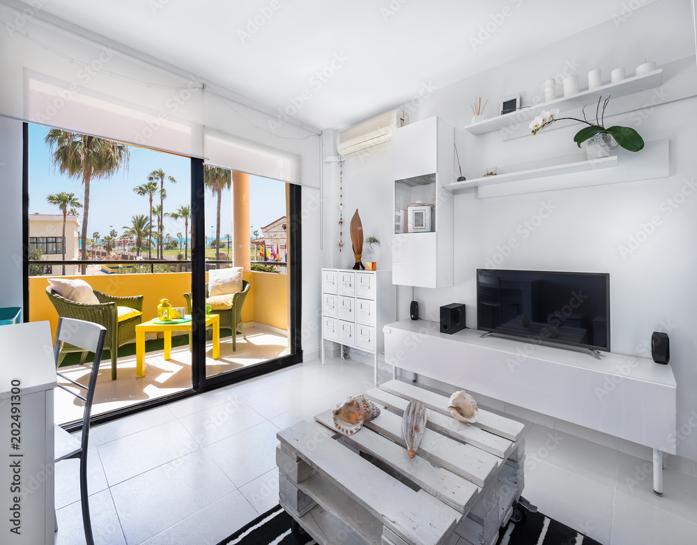 Fototapeta Modern interior decoration of a living room of a holiday destination flat with a