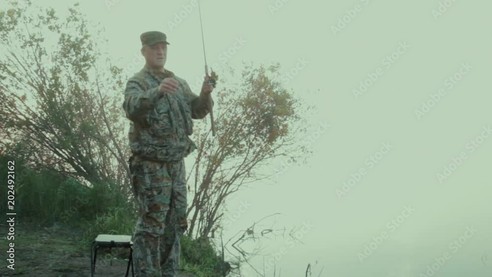 Spinning player changes the place of catching The general plan of the fisherman on an early foggy morning changing the place of catching Spinning player changes the place of catching The general plan of the fisherman on an early foggy morning changing the place of catching