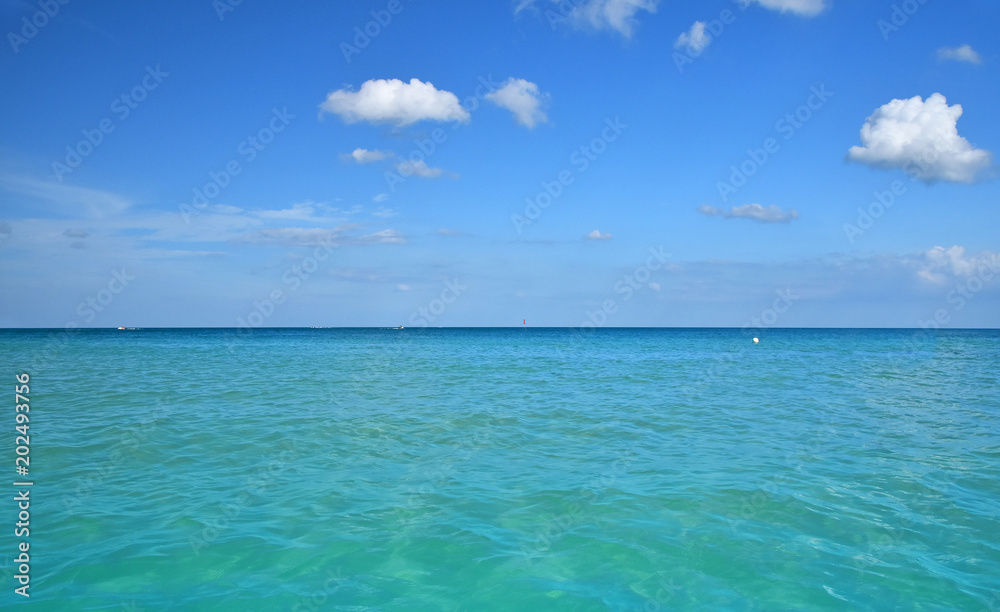 Tranquil scene of blue sea water, horizon and sky