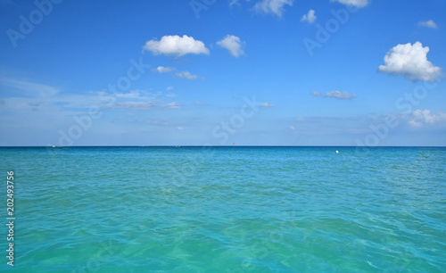 Tranquil scene of blue sea water, horizon and sky