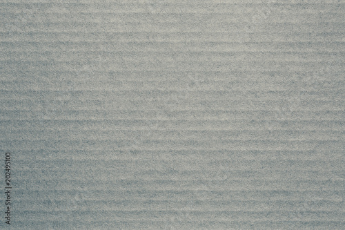 Gray textured surface of cardboard. Can be used as a background