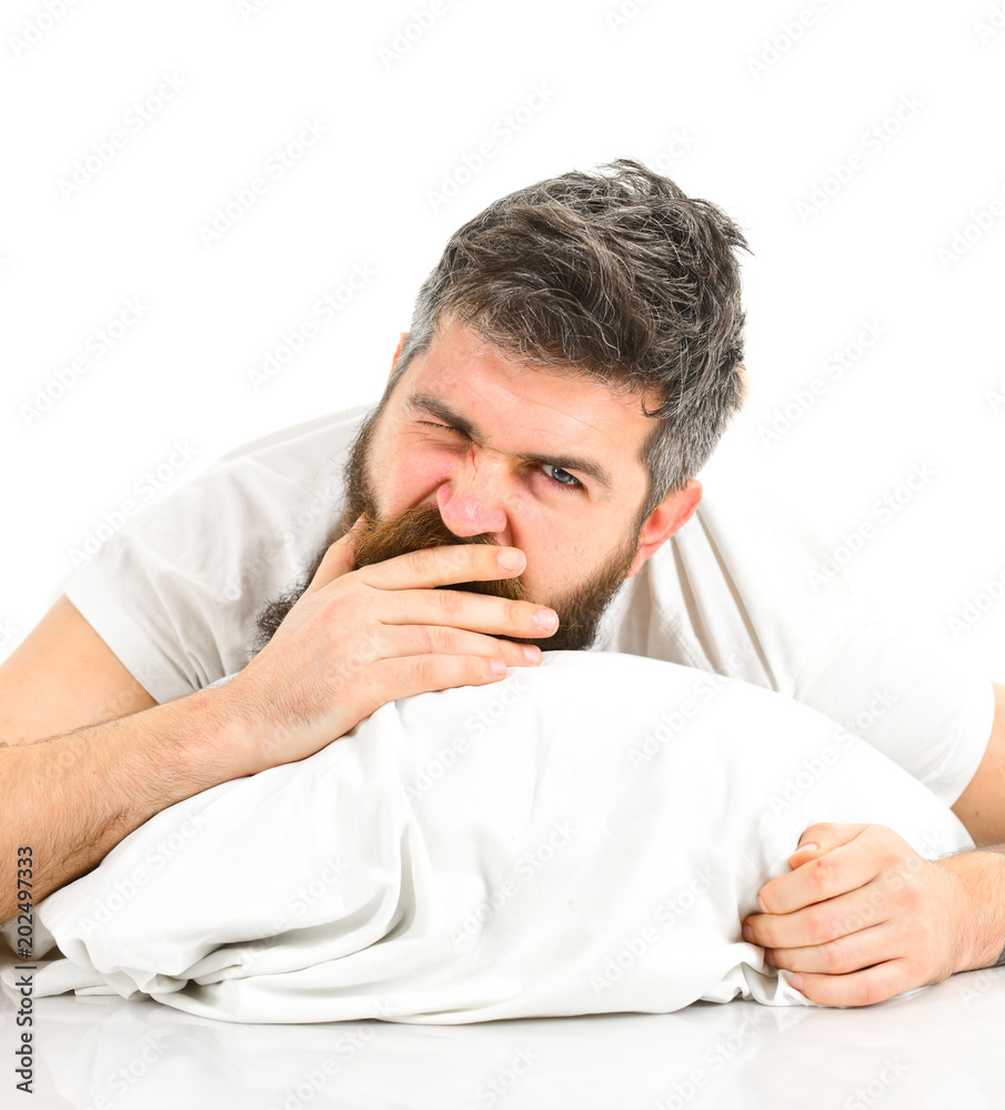 Man with sleepy yawning face lies on pillow. Man with sleepy yawning face lies on pillow.