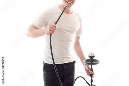 A white man smokes a hookah, holds a in his hand