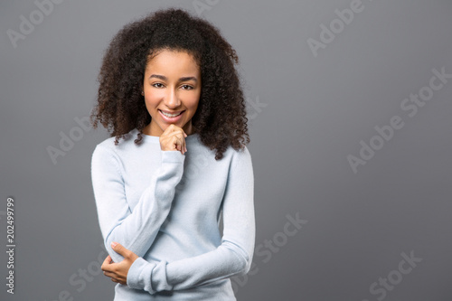 Perfect mood. Nice beautiful woman touching her chin while smiling to you