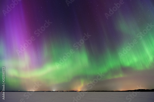 Aurora Borealis, Northern Lights, above frozen lake in Finland.