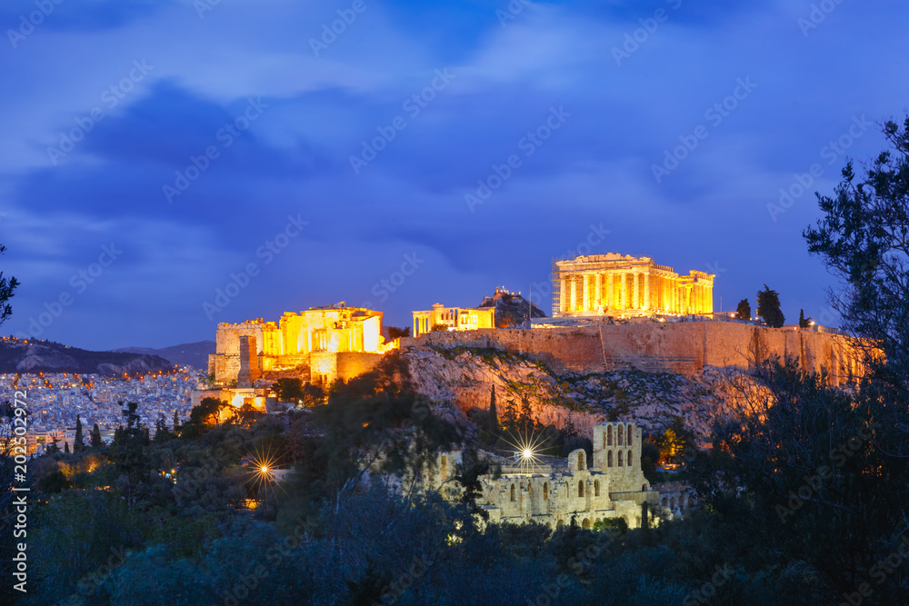 Aerial view of the Acropolis Hill, crowned with Parthenon during evening blue hour in Athens, Greece