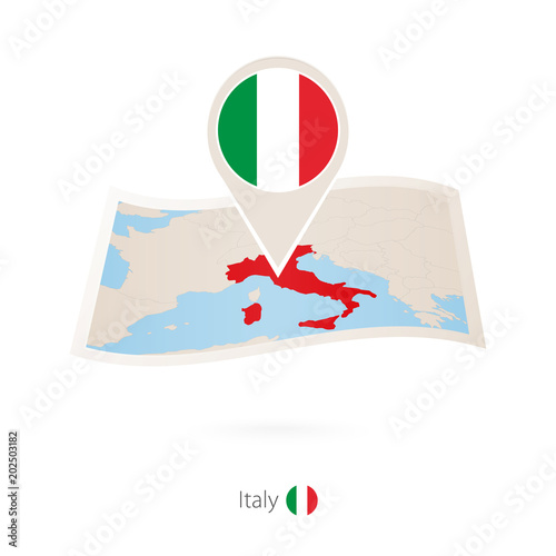 Folded paper map of Italy with flag pin of Italy.
