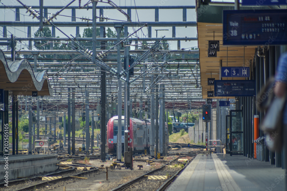 Train station open coverage, rails and train arriving Stock Photo