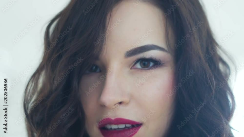 portrait of brunette girl with red lips and earring portrait of brunette girl with red lips and earring