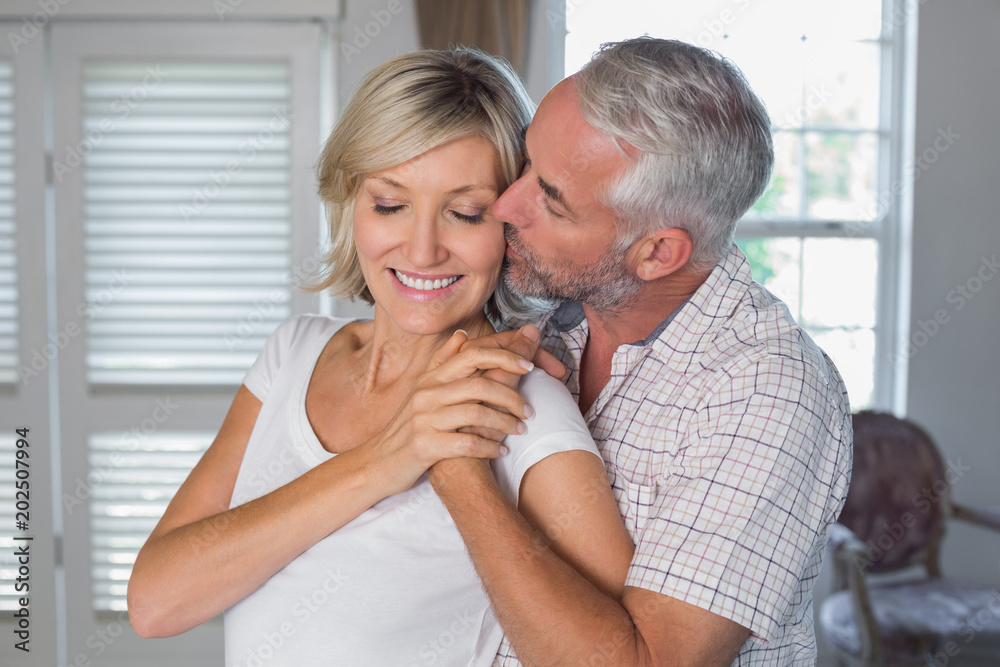 Mature man kissing a happy woman Mature man kissing a happy woman