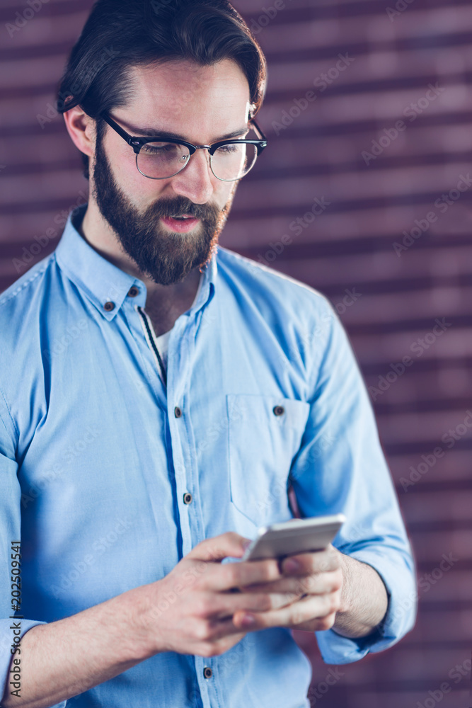Serious man using smartphone Serious man using smartphone