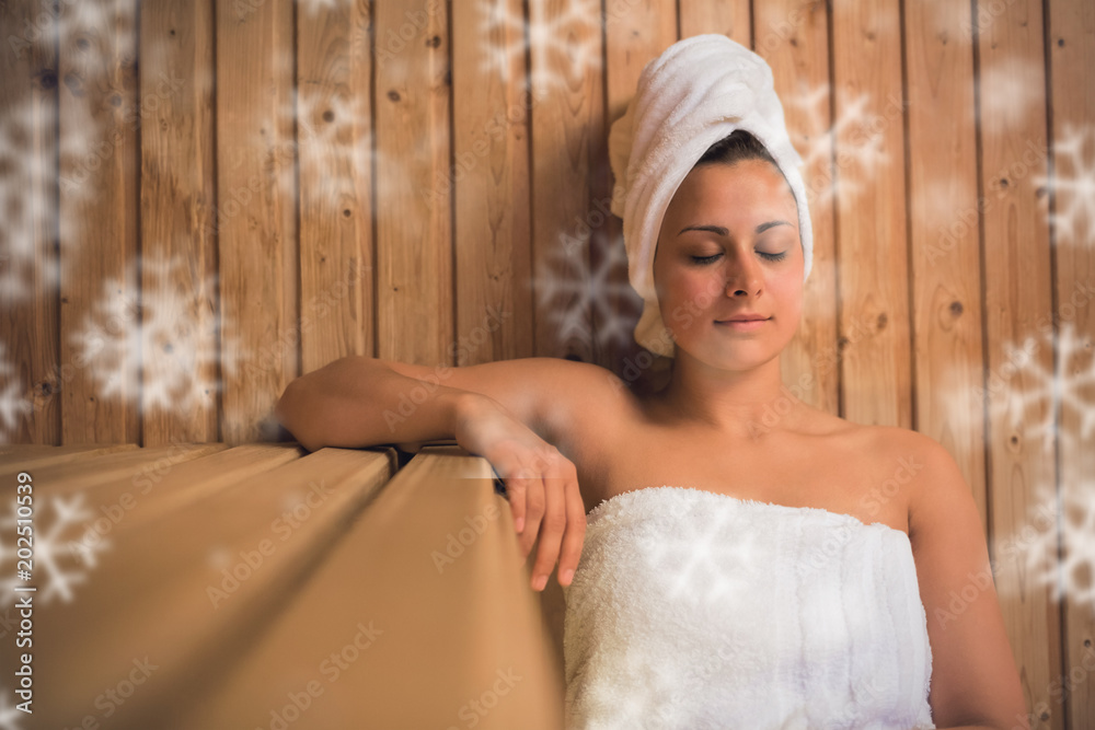 Calm woman relaxing in a sauna against snowflakes Calm woman relaxing in a sauna against snowflakes