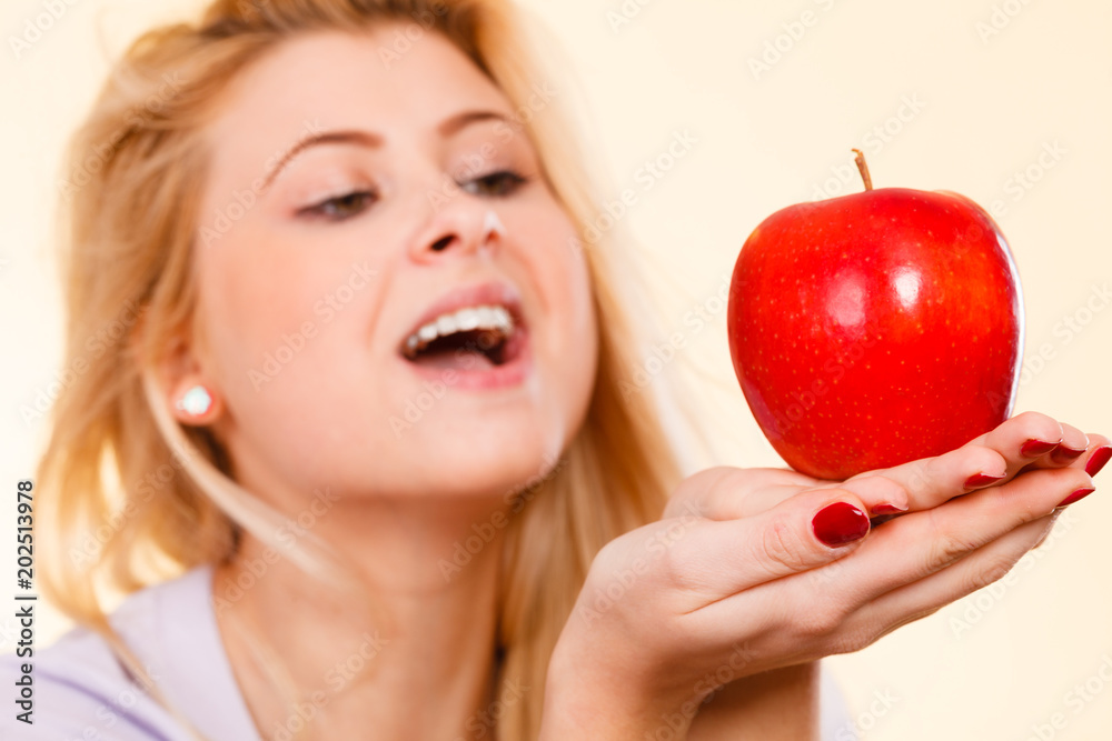 Happy woman holding delicious red apple Happy woman holding delicious red apple