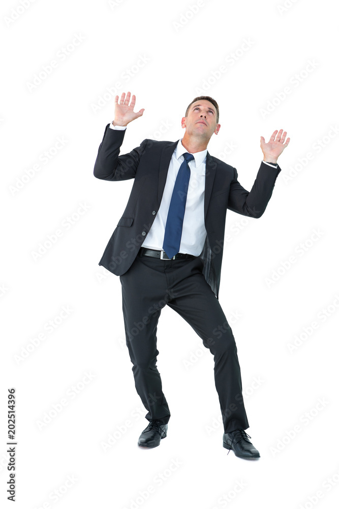 A businessman holding something and looking at top A businessman holding something and looking at top