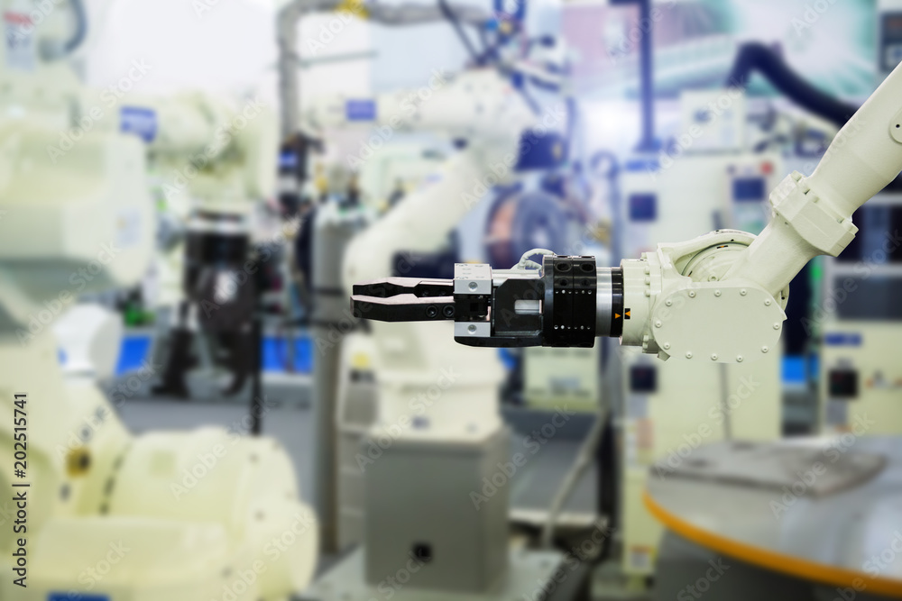 A robotic arm. Automatic robot in a smart factory. Assembly line A robotic arm. Automatic robot in a smart factory. Assembly line
