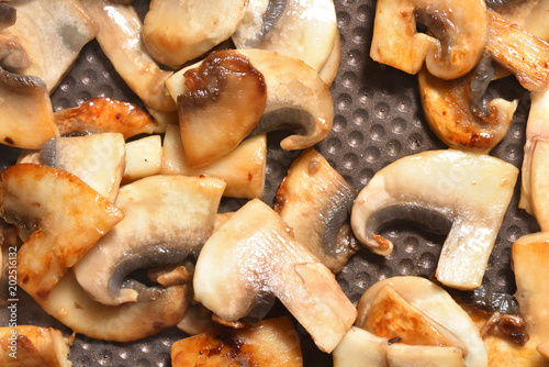 Beautiful fried mushrooms in a frying pan with non-stick coating