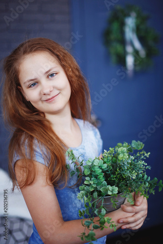 beautiful smiling redhead girl with bouquet of flowers photo