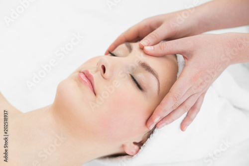 Hands massaging a beautiful womans forehead
