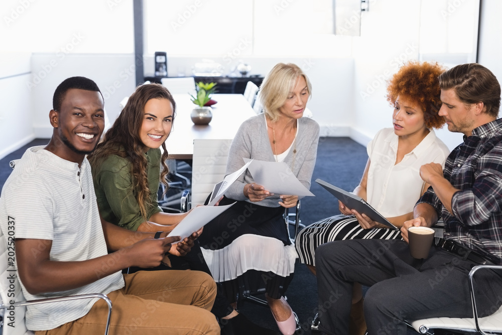 Portrait of smiling business people with colleagues Portrait of smiling business people with colleagues