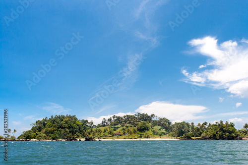 Island paradise with coconut trees and blue sky in the sea of Bahia, Brazil. © Imago Photo