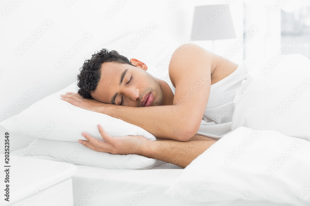 Side view of a man sleeping in bed Side view of a man sleeping in bed