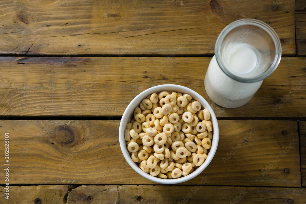 Cereal rings and milk on wooden table Cereal rings and milk on wooden table