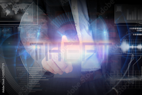 Businessman presenting the word theft against glowing blue pattern on black background