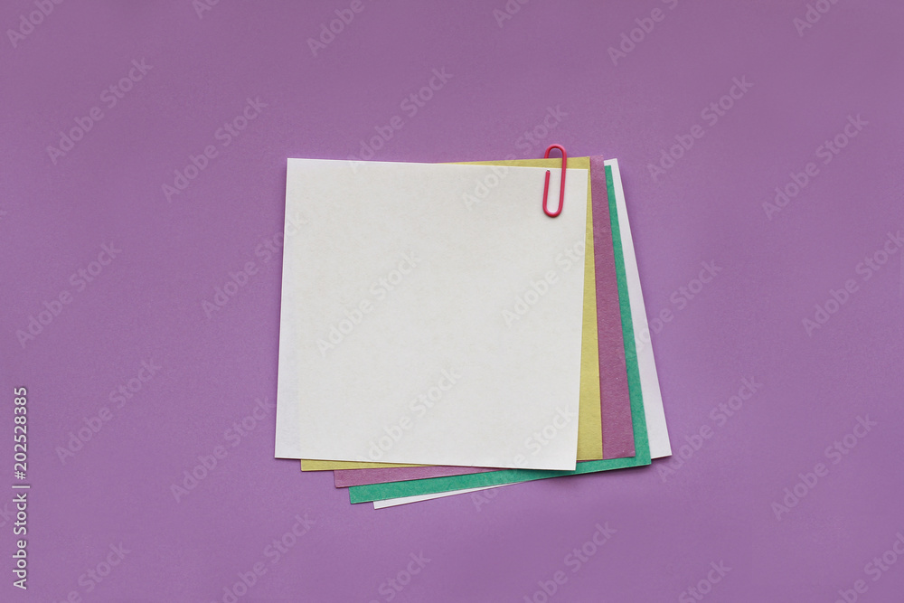 Note papers label with clips on purple background Note papers label with clips on purple background