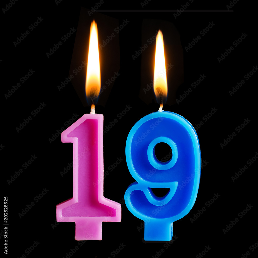 Burning birthday candles in the form of 19 nineteen figures for cake isolated on black background. Burning birthday candles in the form of 19 nineteen figures for cake isolated on black background.