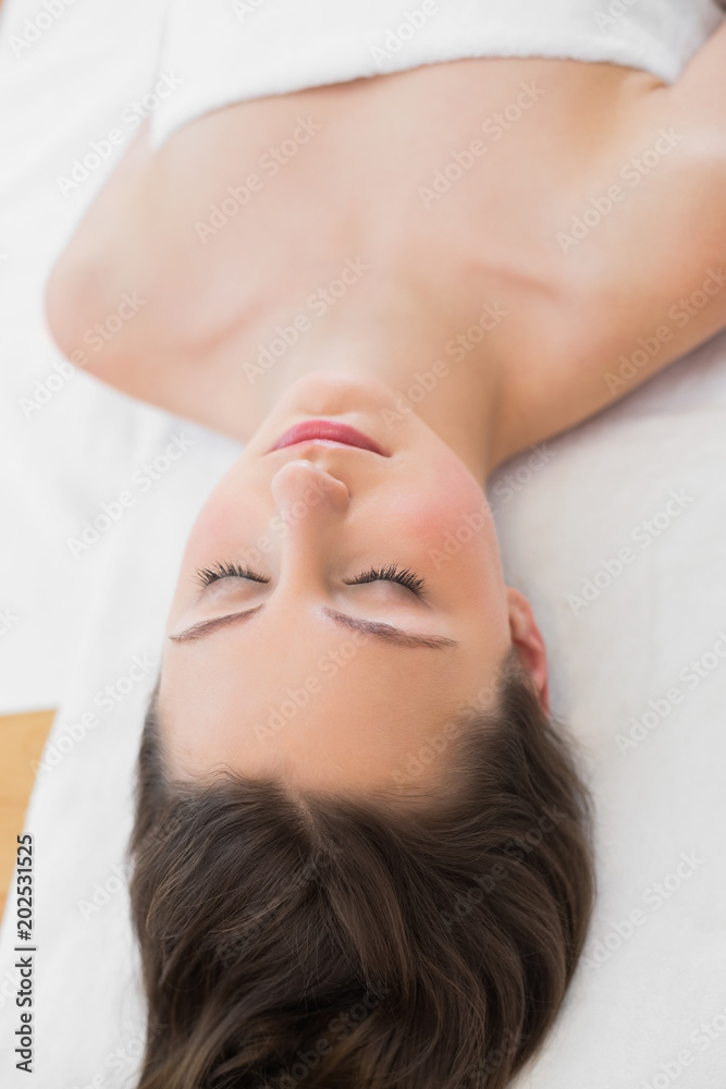 Brunette on massage table with eyes closed Brunette on massage table with eyes closed