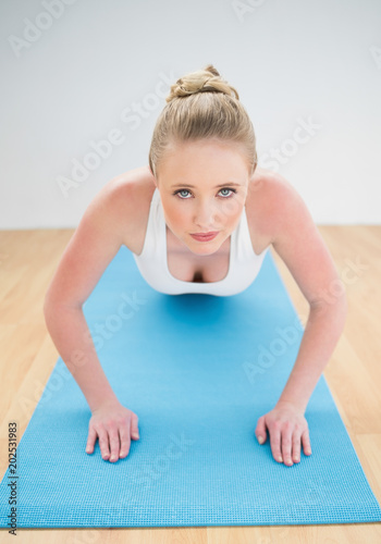 Content sporty blonde doing push ups