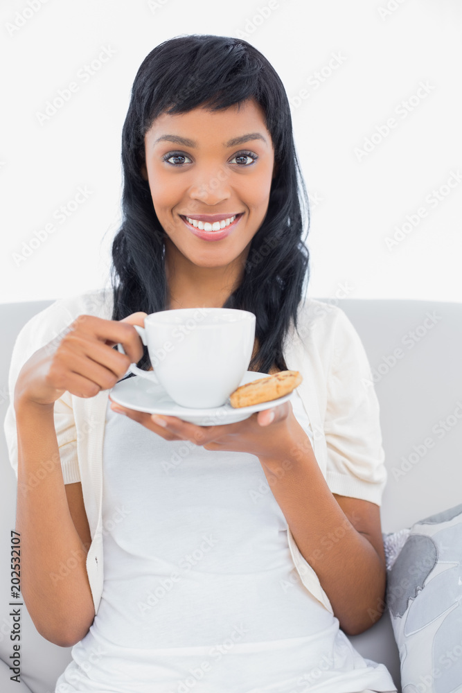 Pleased black haired woman in white clothes drinking coffee Pleased black haired woman in white clothes drinking coffee