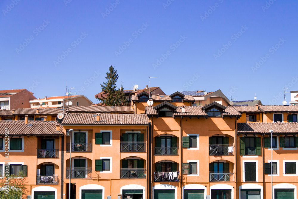 House on a background of sky, a densely populated quarter, private home in Italy