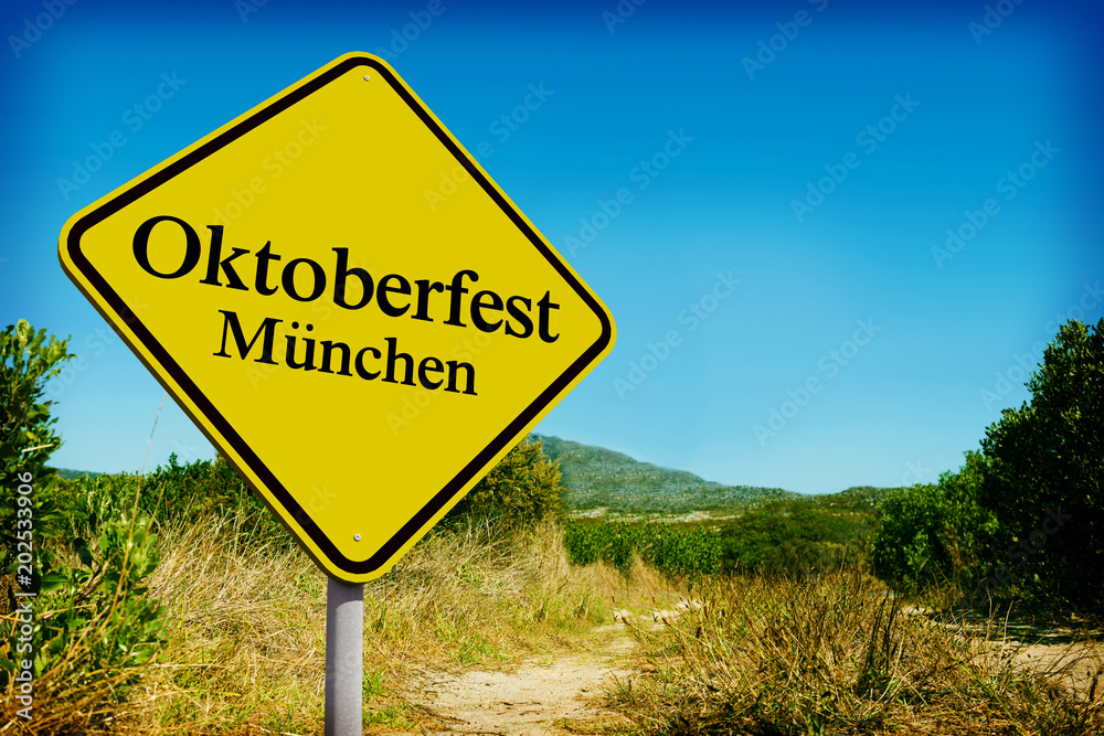 Oktoberfest munchen against yellow road sign by mountain trail