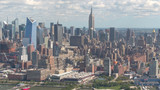 AERIAL: New York City skyscrapers and condominium blocks of flats on sunny day