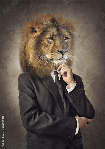 Lion in a suit. Man with a head of an lion. Concept graphic in vintage style.