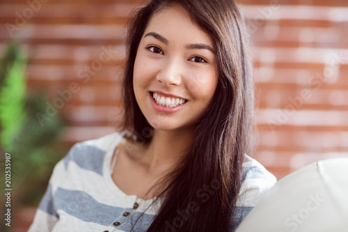 Smiling asian woman on couch