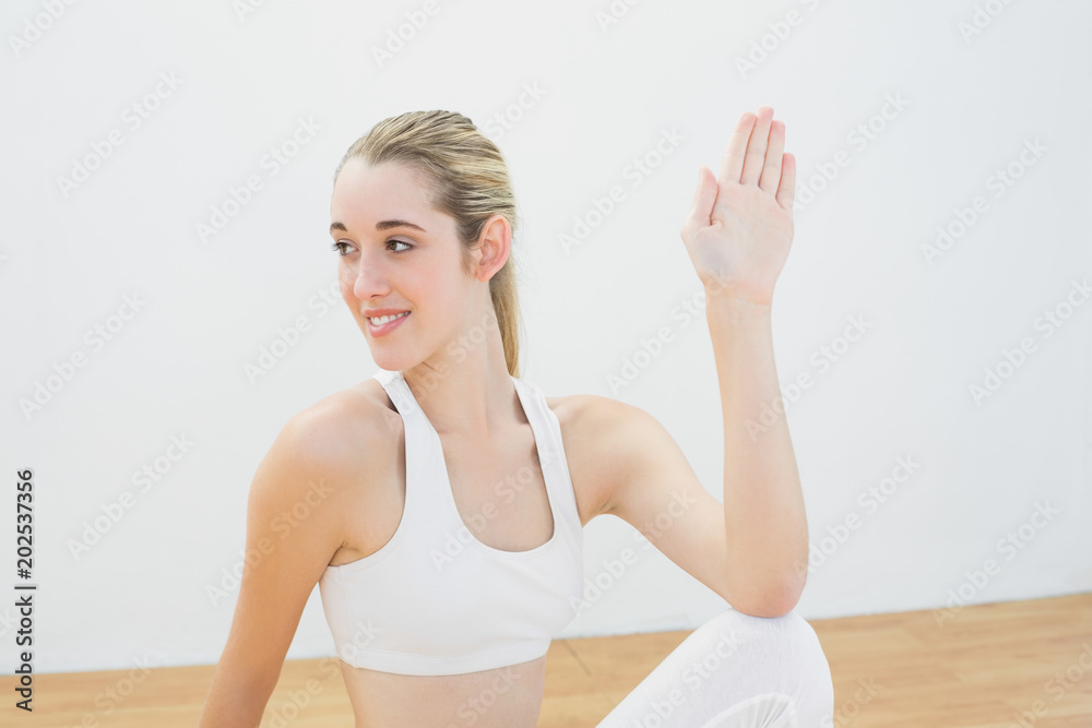 Happy calm woman stretching her body sitting on floor Happy calm woman stretching her body sitting on floor