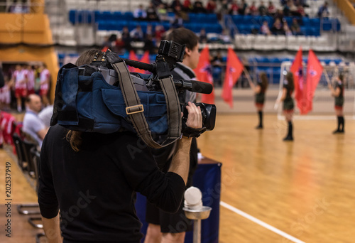 Video operator recording a sports match on a professional video camera