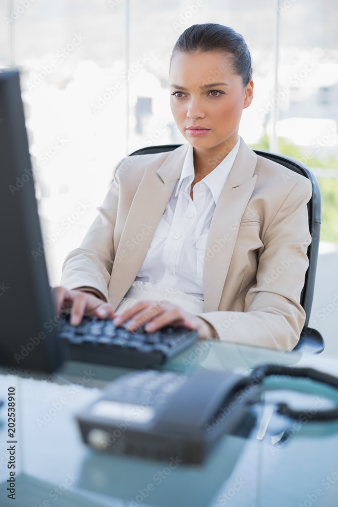 Focused businesswoman working on computer Focused businesswoman working on computer