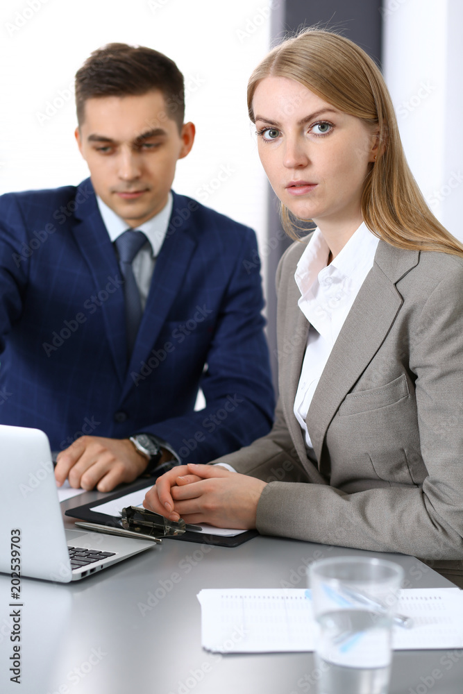 Business people using laptop pc while discussing project in office Business people using laptop pc while discussing project in office