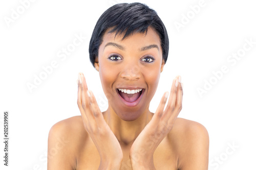 Joyful black haired woman raising her hands