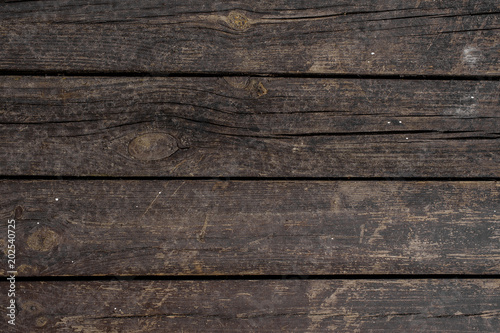 Close up texture background of old dark wooden boards horizontally arranged in a wall