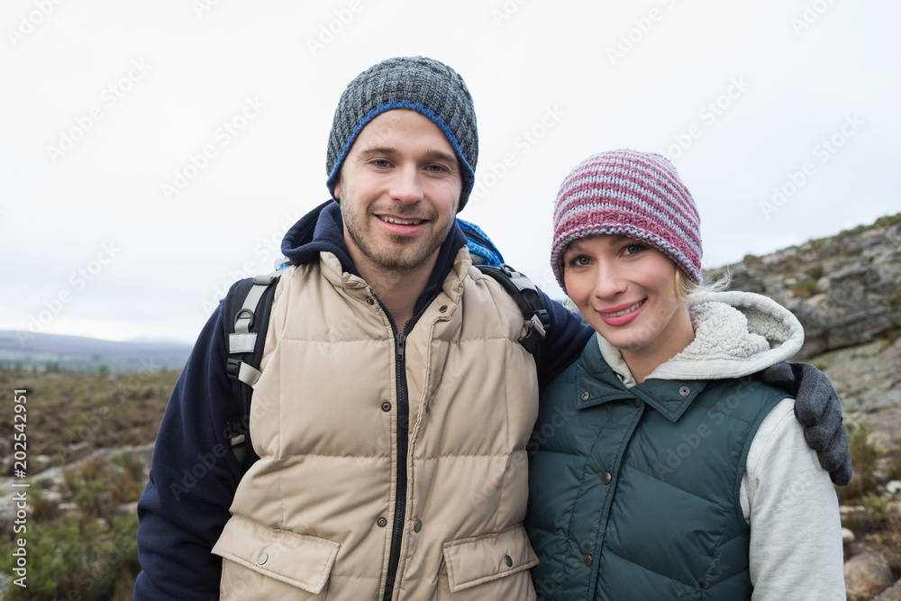 Couple on a hike in the countryside against clear sky Couple on a hike in the countryside against clear sky