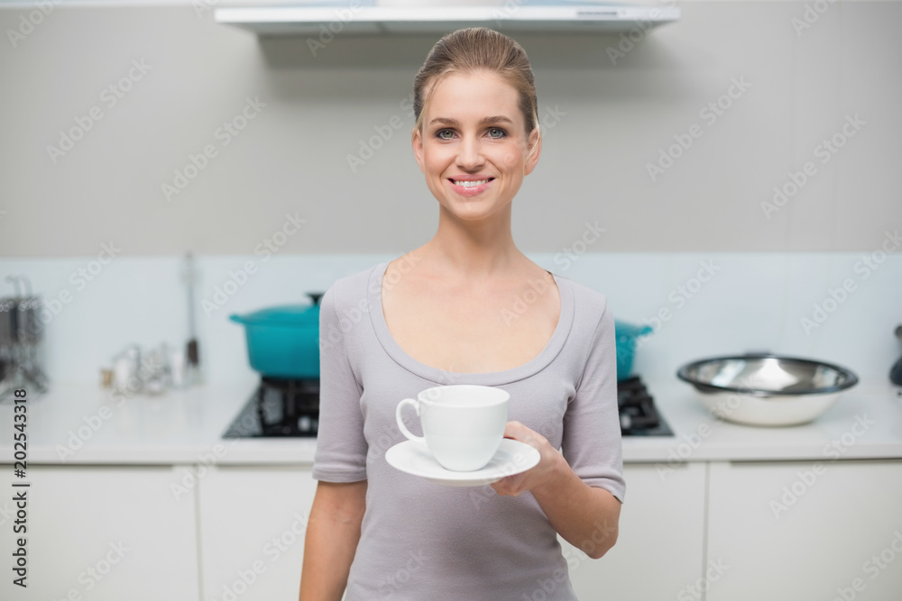 Lucky gorgeous model looking at camera holding mug Lucky gorgeous model looking at camera holding mug