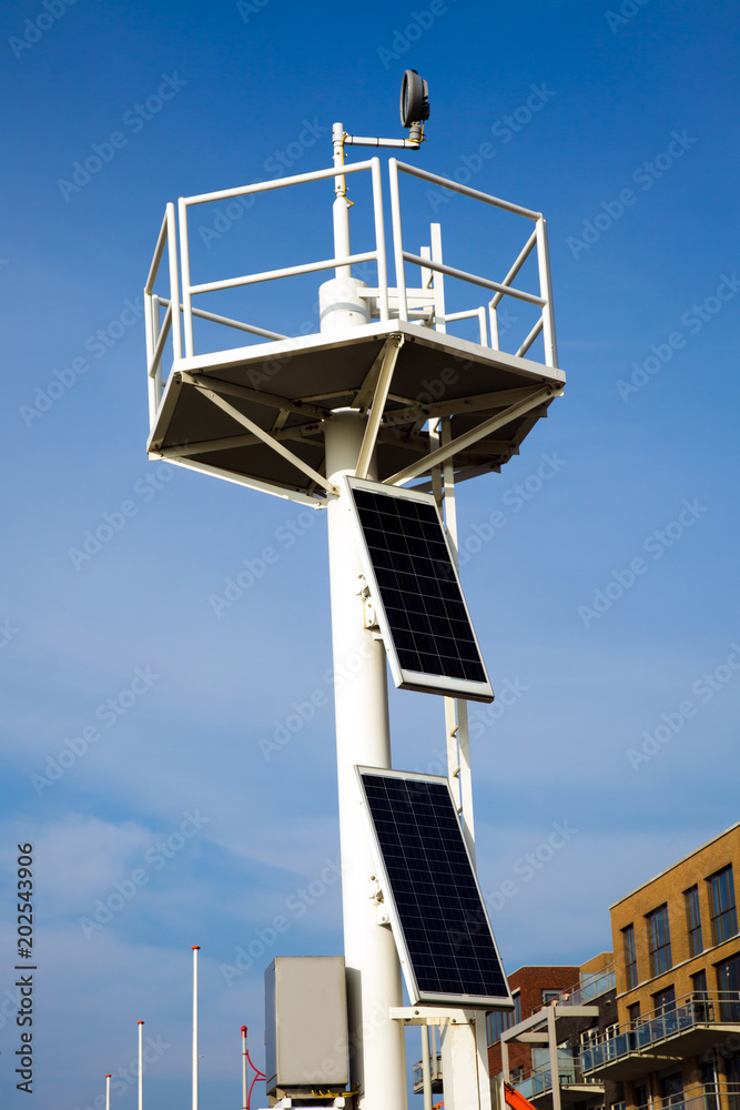 beacon sky solar panels top light house transformation energy blue white sun saving beam two beach port harbor
