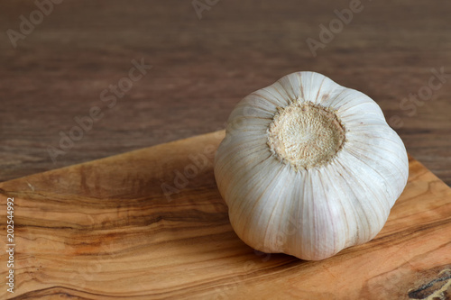 Garlic bulb on wooden board