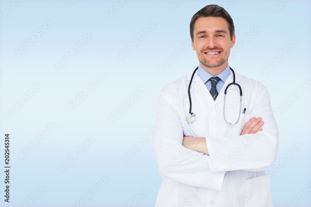 Handsome young doctor with arms crossed against blue vignette background Handsome young doctor with arms crossed against blue vignette background